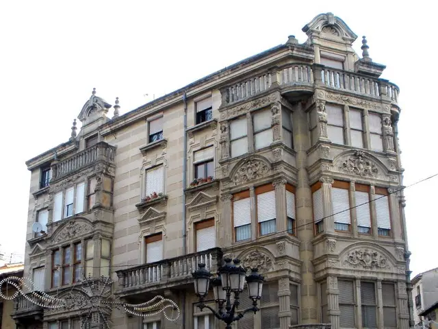 The image shows a large building with a fountain in front of it, surrounded by street poles, street...