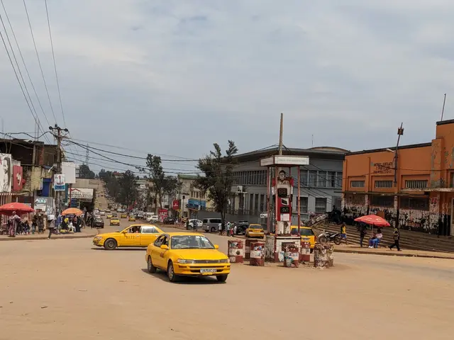 The image shows a bustling city street with a yellow taxi cab driving down it. There are people...