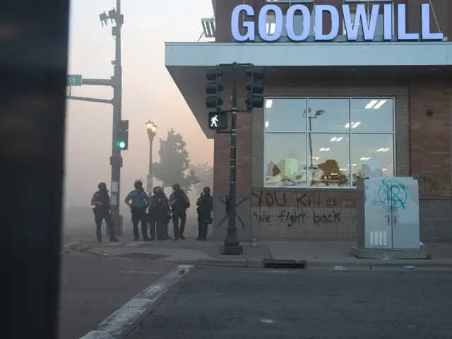 The image shows a group of police officers standing in front of a goodwill store, wearing helmets...