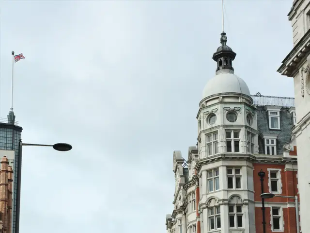 The image shows a bustling city street with a red double decker bus driving down it, surrounded by...