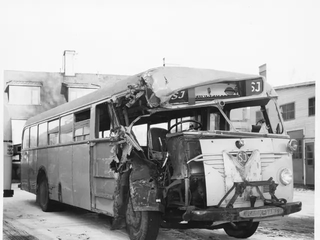 The image shows a black and white photo of a bus that has been involved in a crash on the side of...