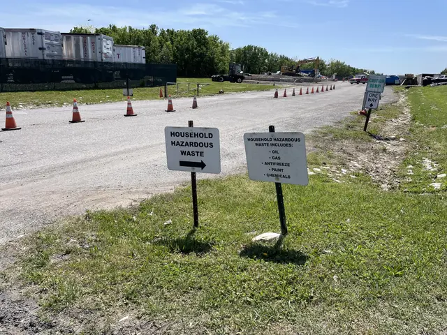 The image shows a road with a sign on the side of it that reads "Household Hazardous Waste"...