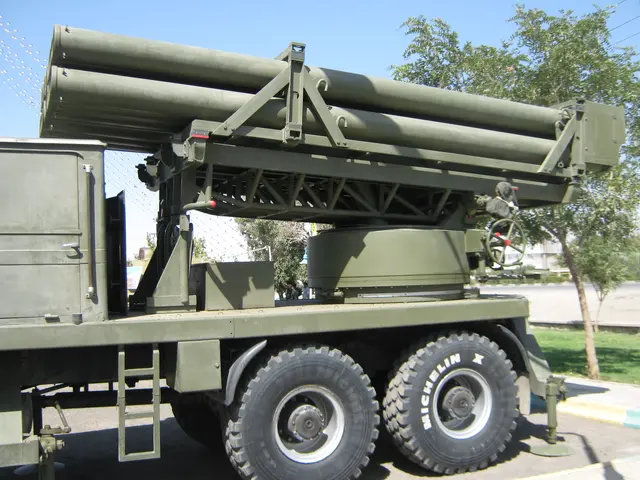 The image shows a military truck with a missile on the back of it driving down a road surrounded by...