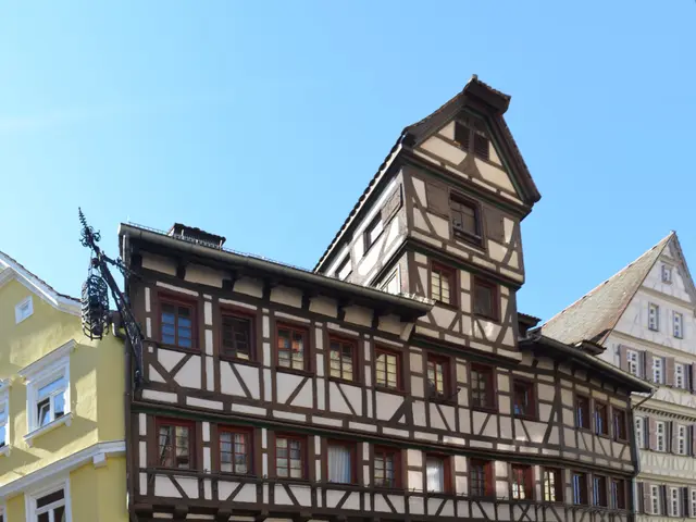 The image shows a cobblestone street in the old town of Rothenburg ob der Tauber, Germany, with a...