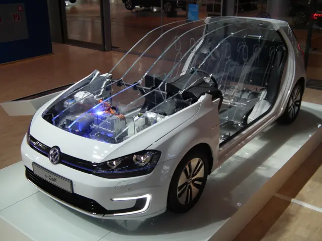 The image shows a white Volkswagen e-Golf electric car on display at the Frankfurt Motor Show,...