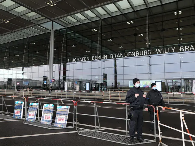The image shows two police officers standing in front of a large building with glass walls and text...