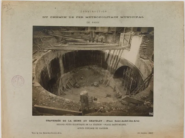 The image shows an old black and white photo of a tunnel under construction, with a stamp on the...