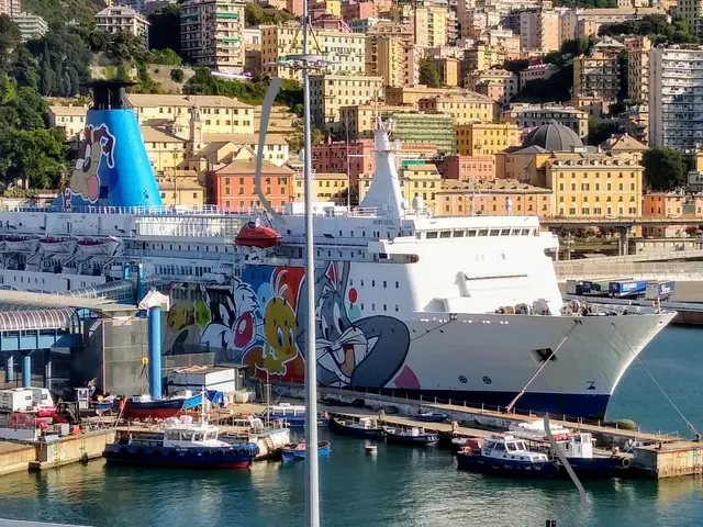 The image shows a large cruise ship docked in the water near a city, with a bridge on the left side...