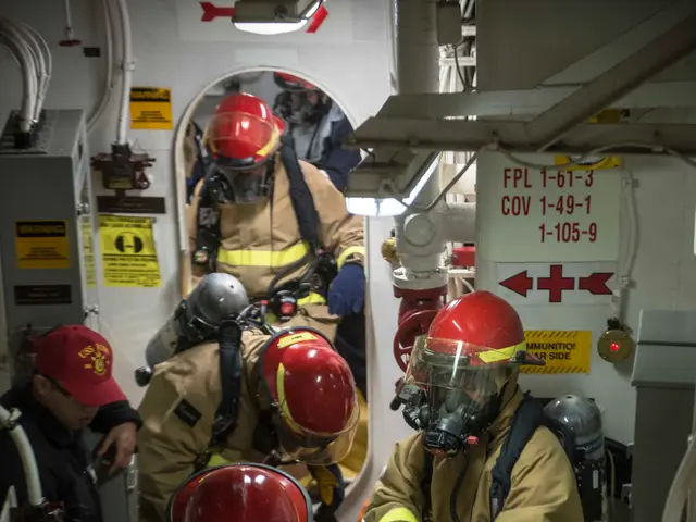 The image shows a group of firefighters in protective gear, including helmets, gloves, and oxygen...