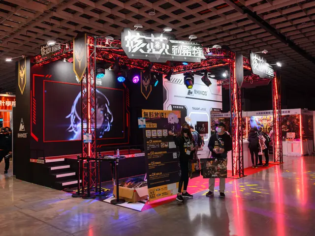 The image shows a group of people standing in front of a booth at a trade show, illuminated by...