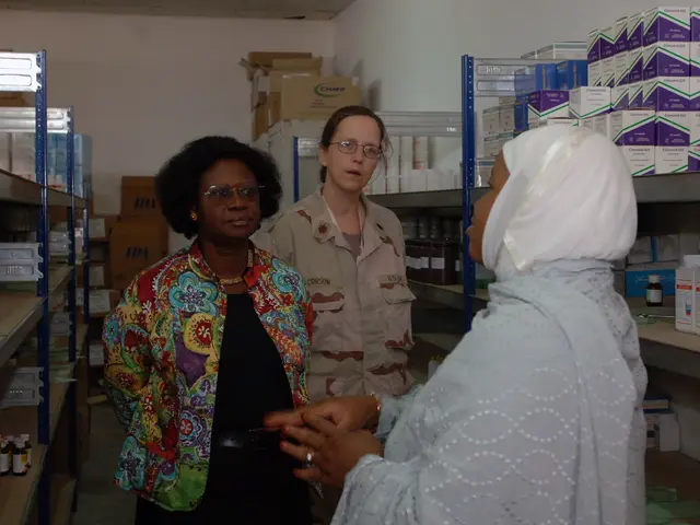 The image shows three women standing in a pharmacy, talking to each other. On either side of them...