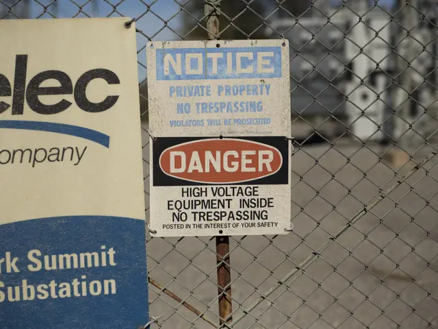 The image shows a chain link fence with two signs attached to it, one of which reads "Notice" and...