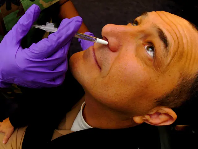 The image shows a man getting a vaccine from a doctor wearing purple gloves. The doctor is holding...