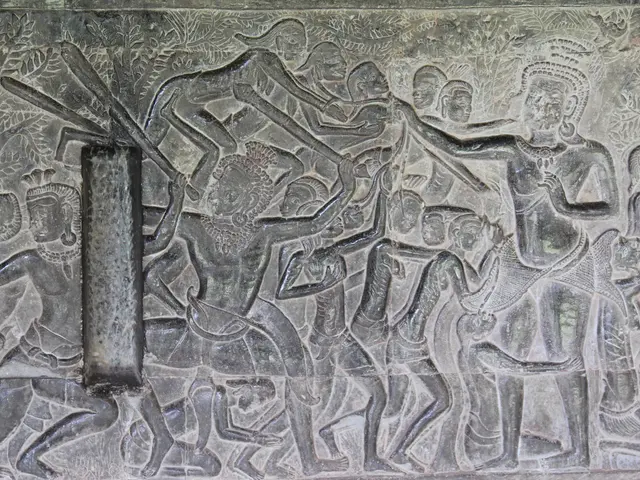 The image shows a stone carving on the wall of a temple in Angkor Thom, Cambodia depicting a scene...