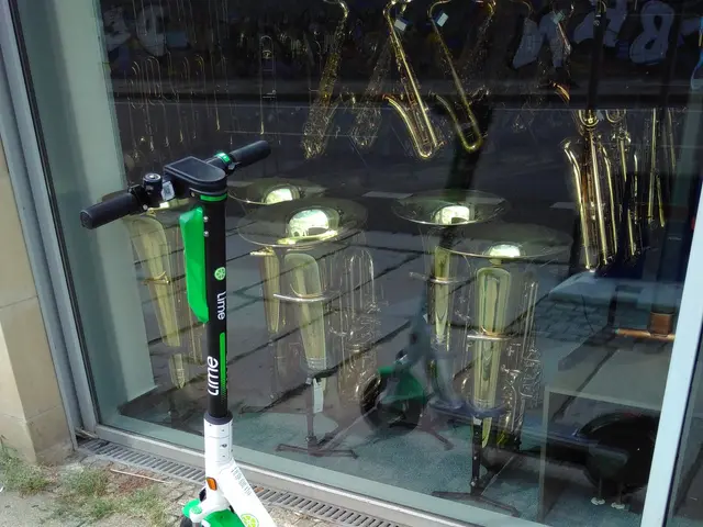 The image shows an electric scooter parked on the sidewalk in front of a store, with a glass wall...