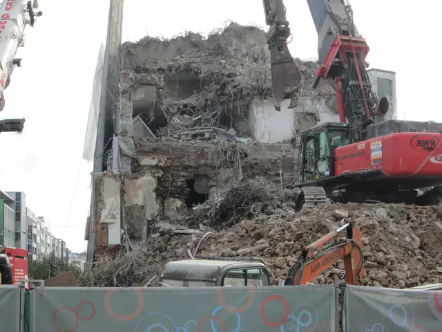 The image shows a demolition of a building with a crane in the foreground, surrounded by cranes,...