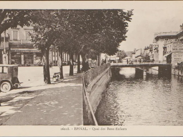 The image shows an old black and white photo of a river with a bridge in the background. On the...