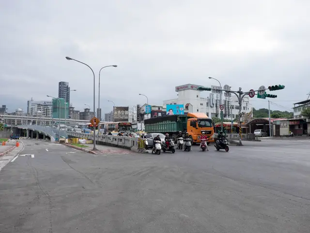 The image shows a city street filled with lots of traffic, including a truck and a car. There are...