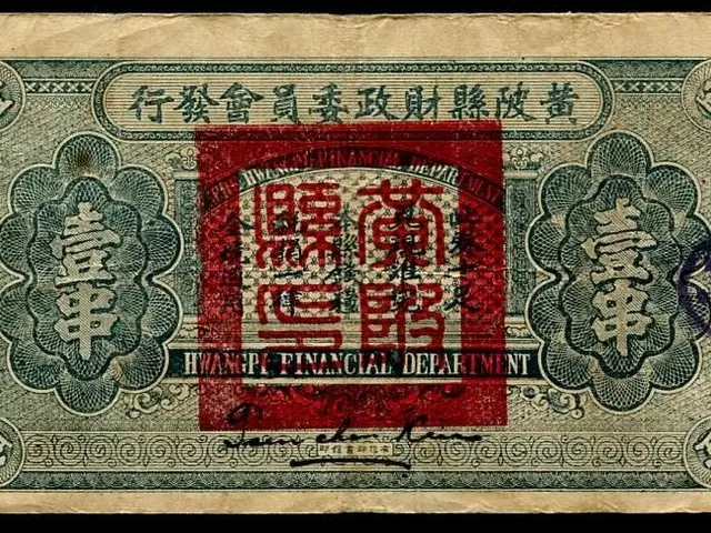 The image shows an old Chinese banknote with Chinese writing on it against a black background. The...