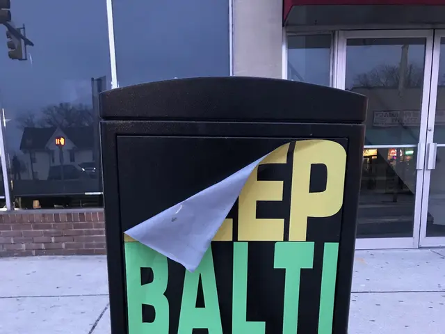 The image shows a black trash can with the words "Keep Baltimore More Clean" written on it, sitting...