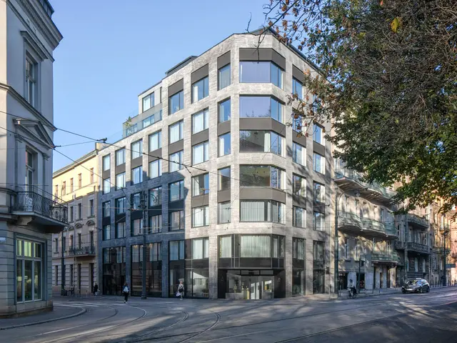 The image shows a large building with many windows on the side of it, surrounded by street poles,...