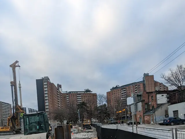 The image shows a construction site with a bulldozer parked on the side of the road, surrounded by...