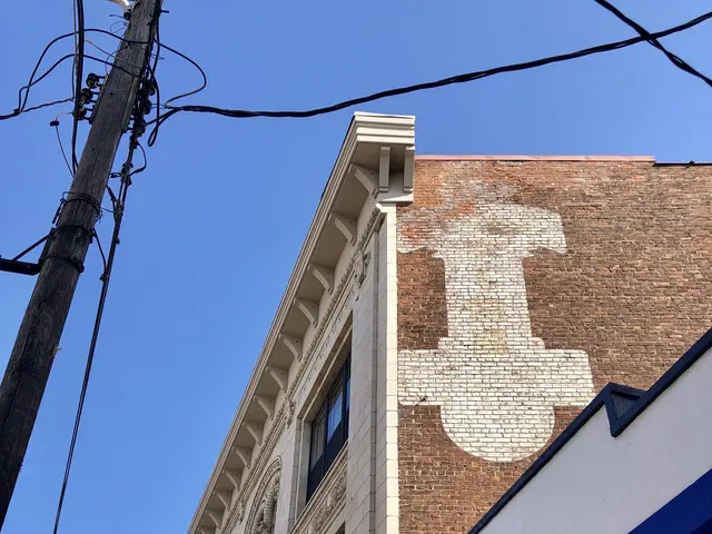 The image shows an old town cafe on the corner of a street, with buildings, name boards, electric...
