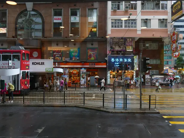 The image shows a bustling city street with a red double decker bus driving down it, surrounded by...