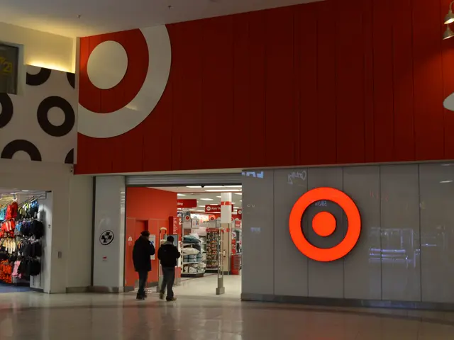 The image shows a Target store in a shopping mall with people walking through it. There are clothes...