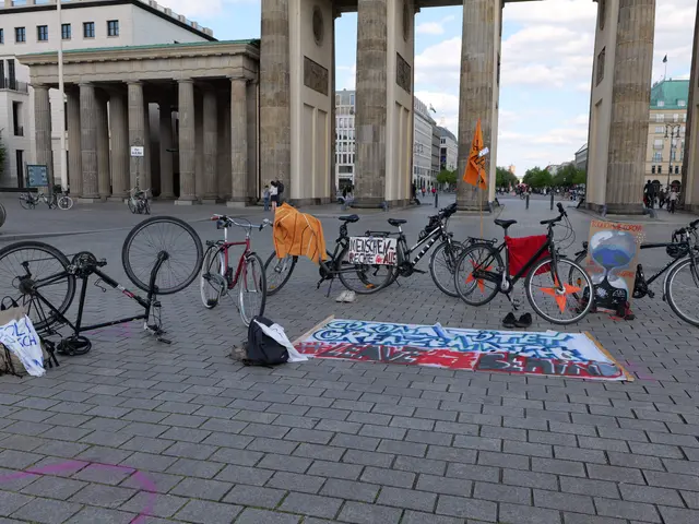 The image shows a group of bicycles parked in front of the Brandenburg Gate in Berlin, Germany....