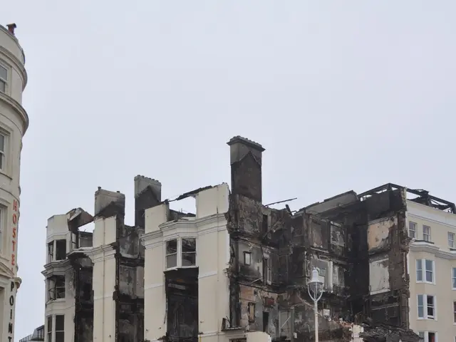 The image shows a police car parked in front of a building that has been destroyed, with its...