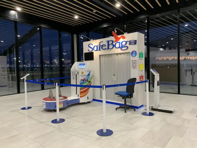 The image shows a safe bag check-in counter at an airport, with a chair, barrier poles, machines, a...