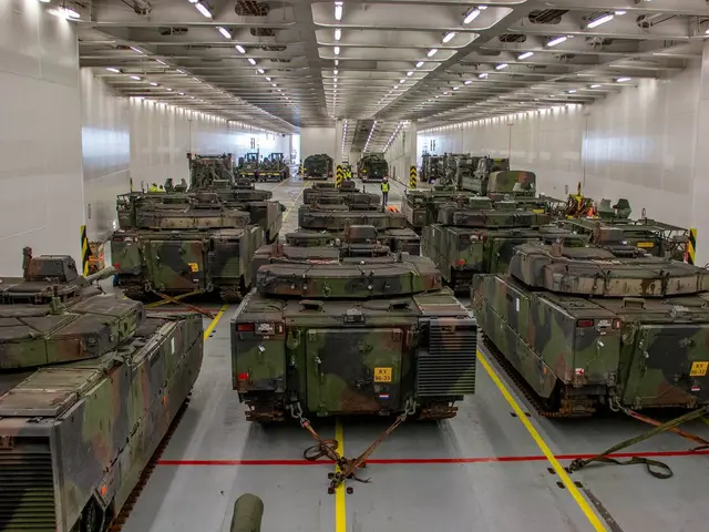 The image shows a large room filled with lots of military tanks, with walls on either side and a...