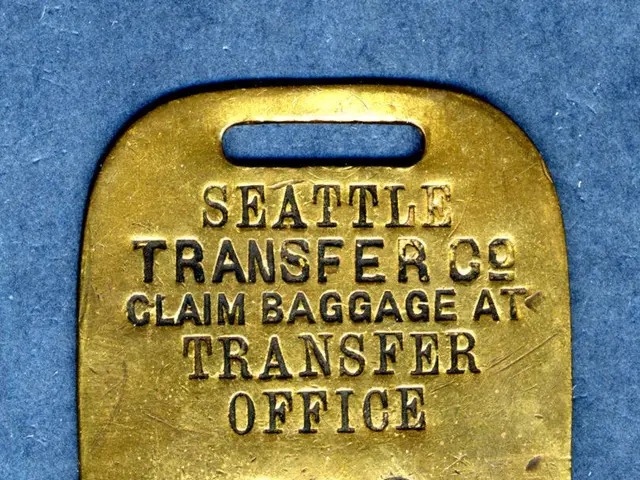 The image shows a gold luggage tag with the words "Seattle Transfer Co. Claim Baggage at Transfer...