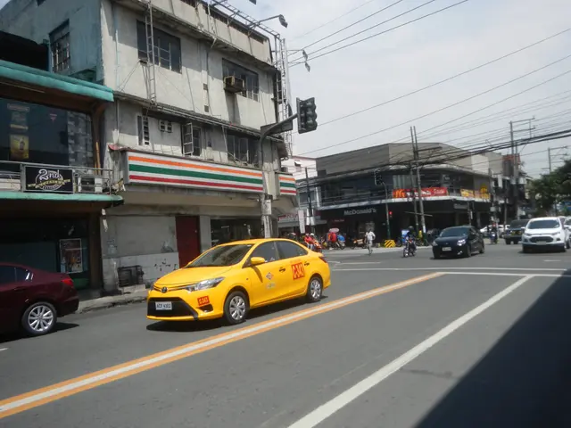 The image shows a yellow taxi cab driving down a street lined with tall buildings. There are people...