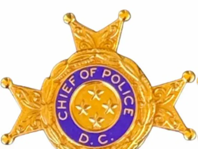 The image shows a police badge with the words "Chief of Police" written on it against a white...