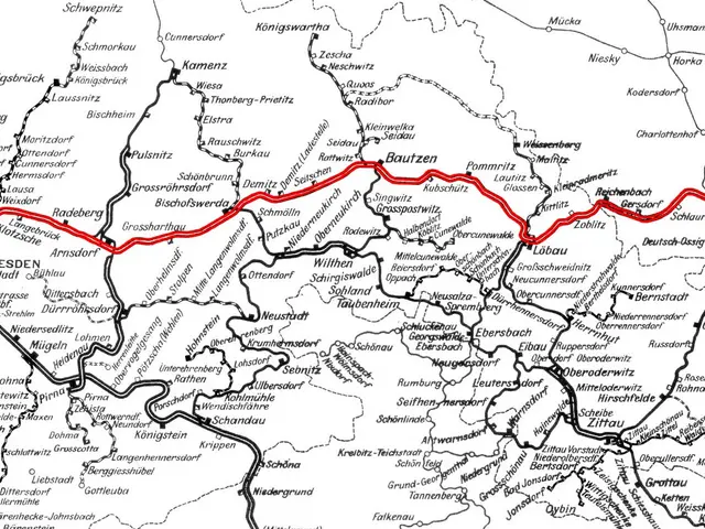 The image shows a black and white map of Germany with a red line running through it, indicating the...