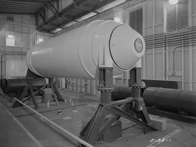 The image shows a black and white photo of a large cylindrical object, which appears to be a...