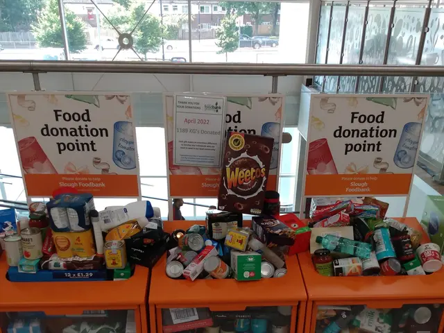 The image shows a food donation point in a building with orange cabinets filled with food items...