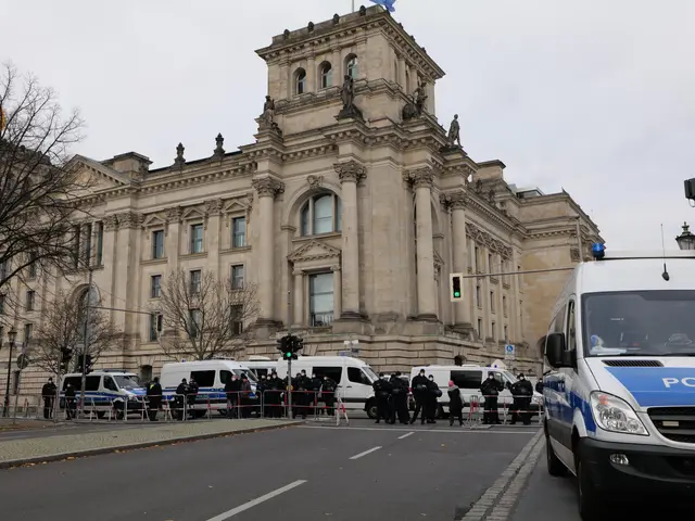 The image shows a group of police officers standing in front of the Reichstag building in Berlin,...