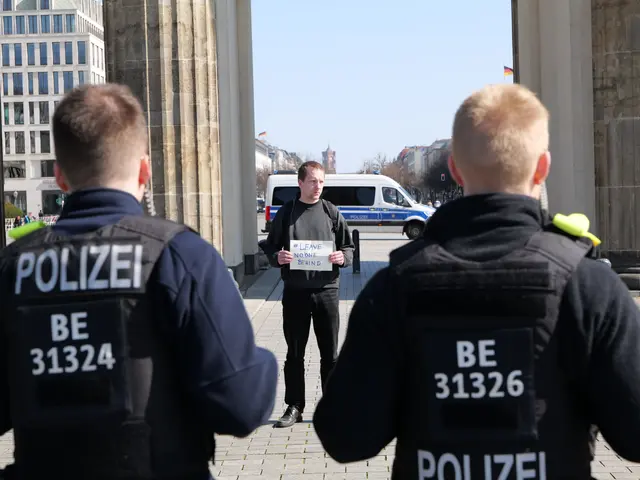 The image shows three police officers standing in front of a building, with a man in the middle...