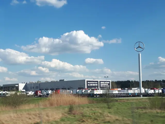 The image shows a Mercedes-Benz factory in Germany, with vehicles on the road, grass, plants,...