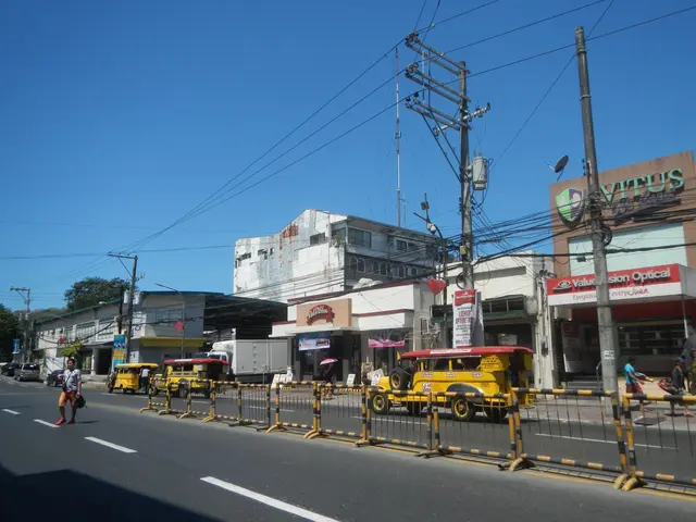 The image shows a city street filled with lots of traffic next to tall buildings. We can see...
