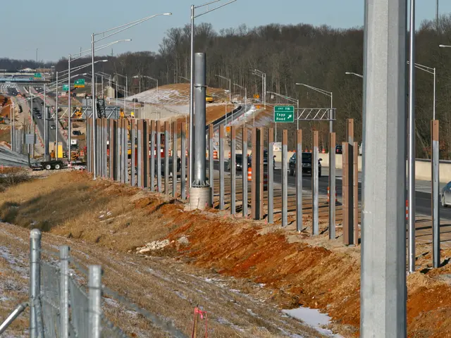 The image shows a construction site with a lot of traffic on it, including vehicles on the road,...