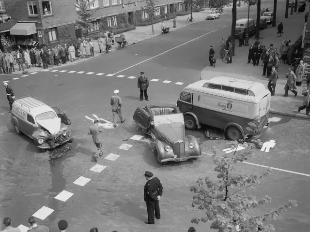 The image shows a black and white scene of a car accident on the corner of a street. There are...