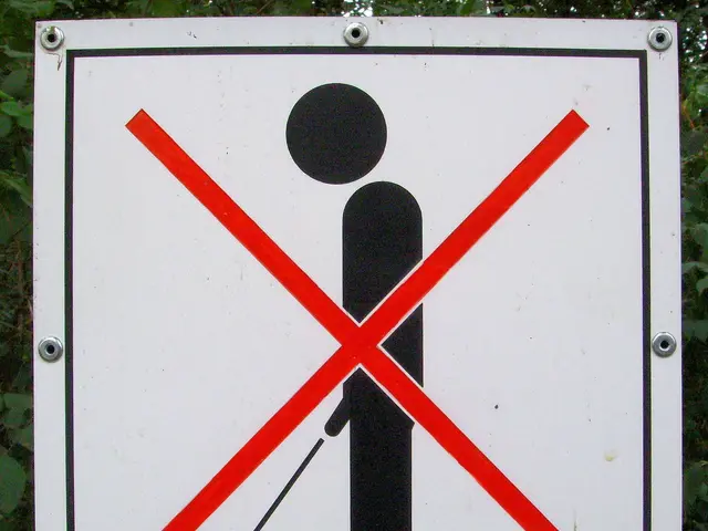 The image shows a no parking sign attached to a pole in the woods, with trees in the background....