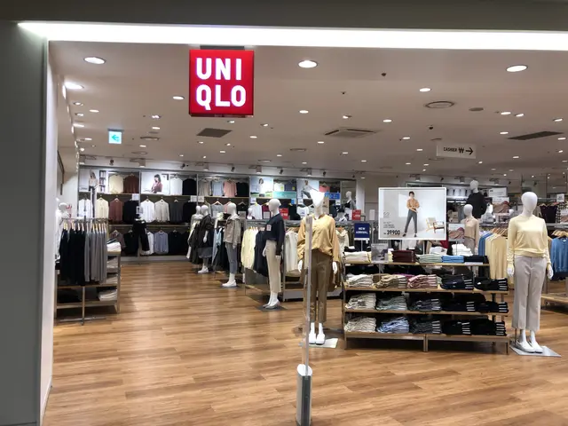 The image shows the inside of a clothing store with mannequins wearing clothes, clothes hung on...