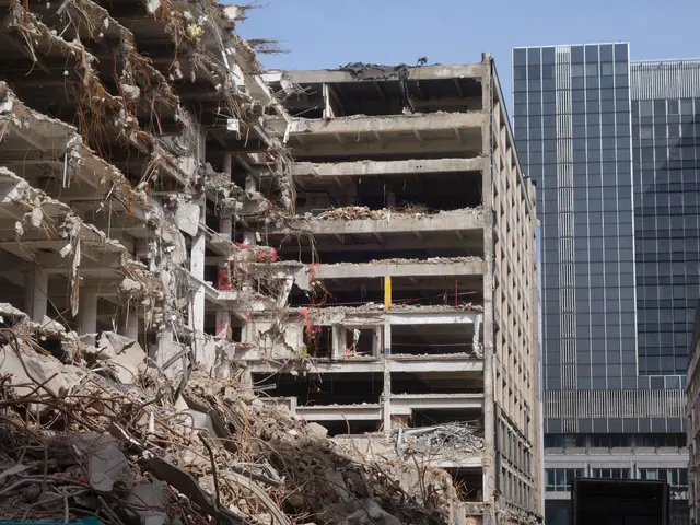 The image shows a large building that has been demolished in the middle of a city, surrounded by...