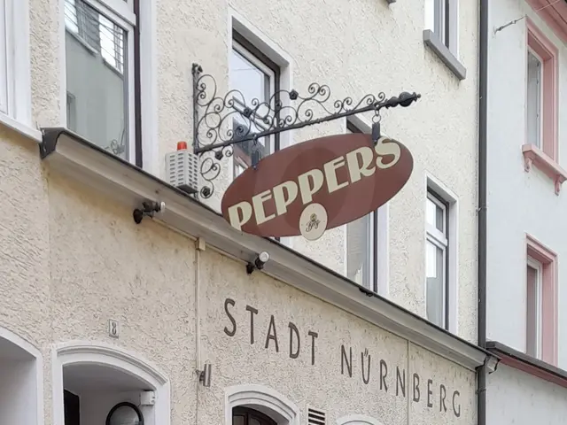 The image shows a building with a sign that reads "Stadt Nurnberg" on the side of it. The building...