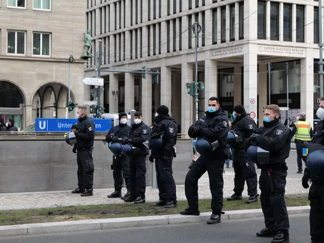 The image shows a group of police officers standing in front of a building in Berlin, Germany. They...